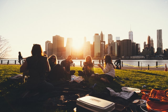 Image of a group of friends enjoying together with a landscape of the city behind them