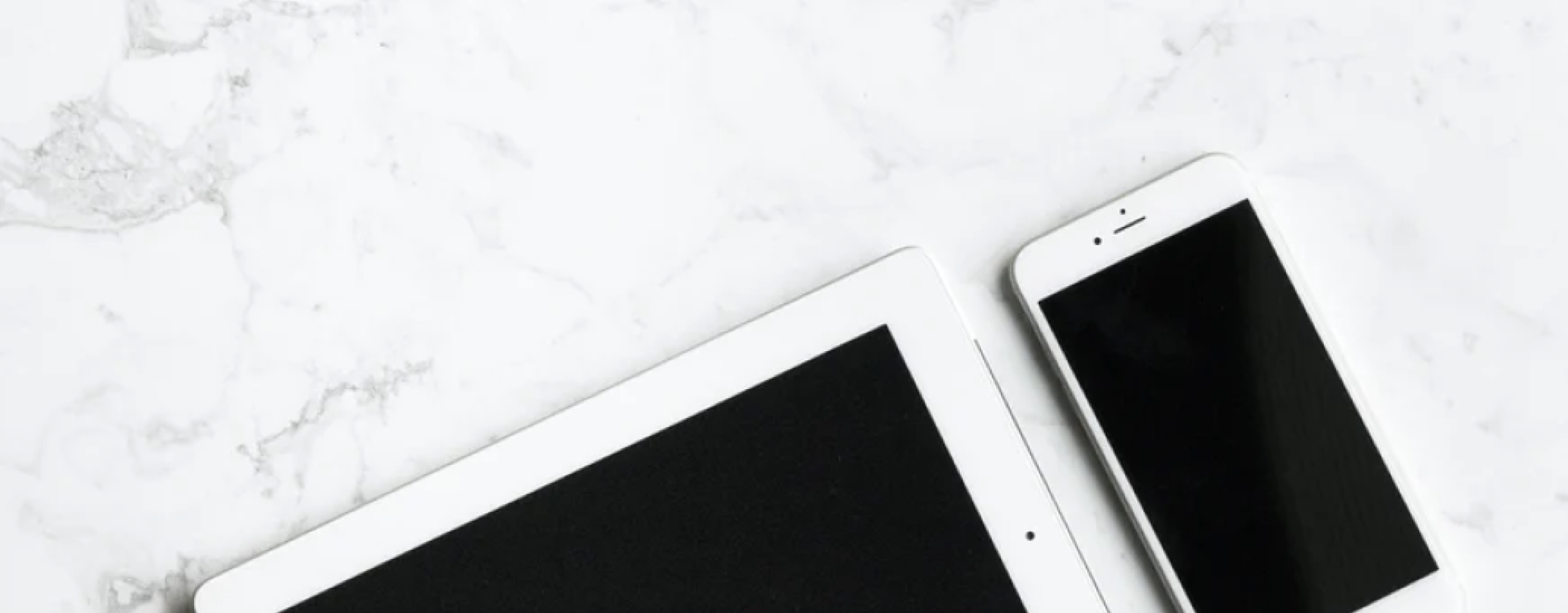 Phone and tablet on a granite countertop