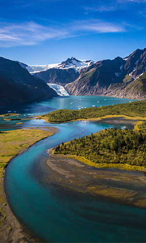 View of a river, forest, and mountains